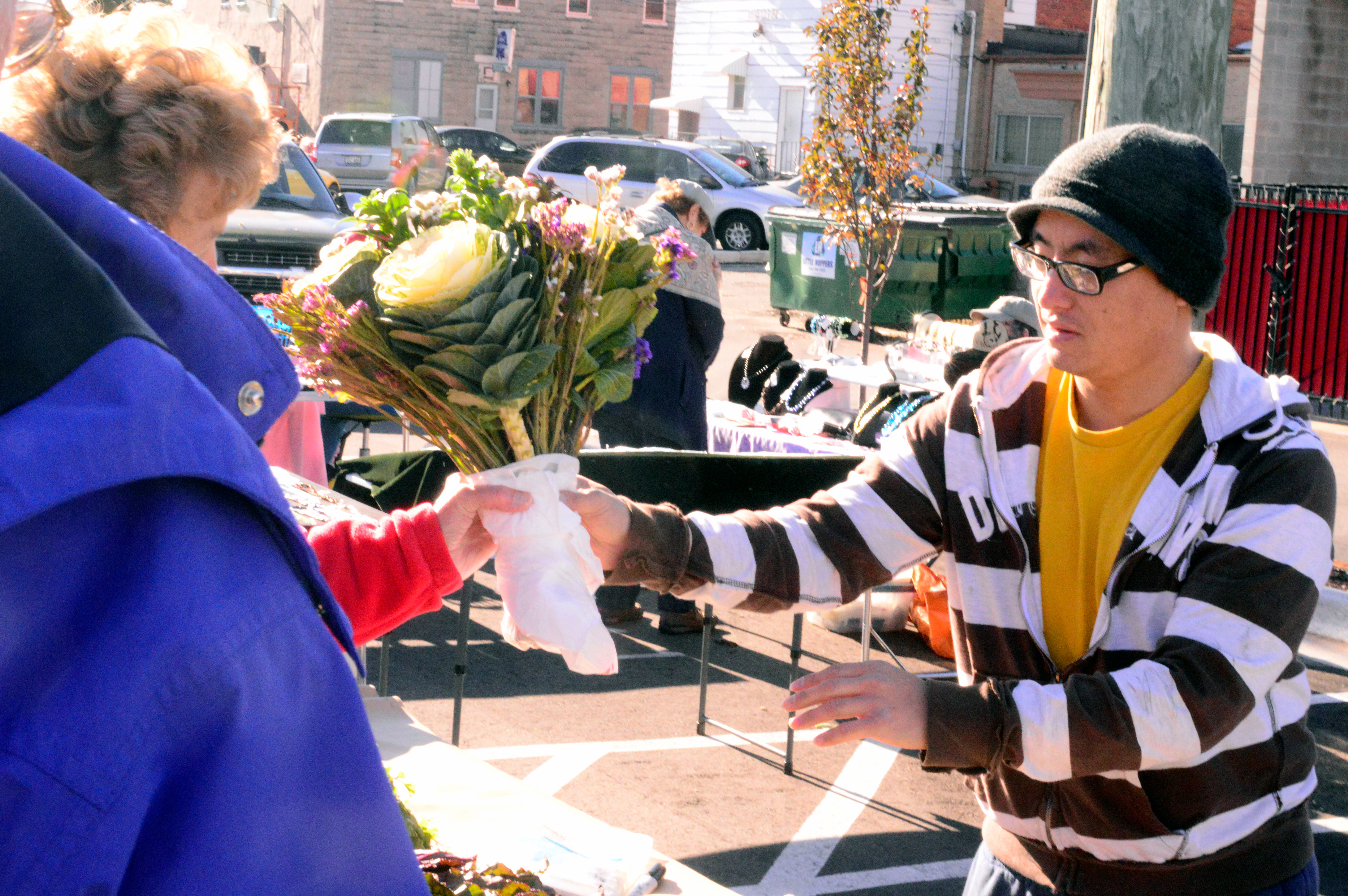 Customer buying cut flowers.