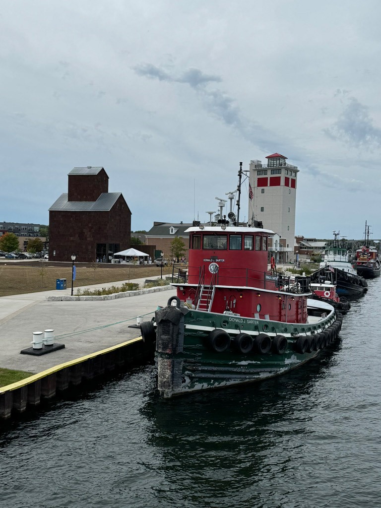 Donald J. Sarter tug i foreground Door County Granary's Soft Opening.